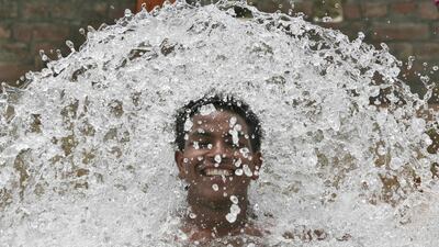 A boy cools himself in the waters of a tube well on a hot summers day at Manawala village on the outskirts of Amritsar, India. Munish Sharma / Reuters