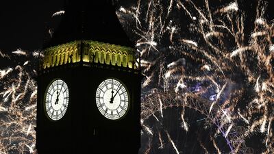 Fireworks light up the sky over Elizabeth Tower, also known as Big Ben, and the London Eye in central London during the New Year celebrations. PA