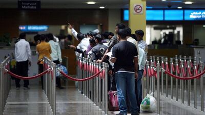People wait in line at the passport control area in Terminal 1 arrivals section at the Dubai International airport in Dubai. Randi Sokoloff / The National