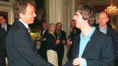The former British prime minister Tony Blair talks to the Oasis star Noel Gallagher at a Downing Street reception. Gallagher was a big supporter of the Labour party under Blair.