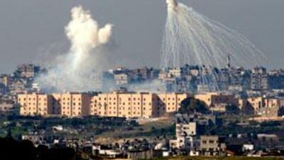 A weapons system fired by Israeli forces explodes over the northern Gaza Strip.