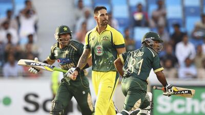 Mitchell Johnson, centre, of Australia looks on during the second one-day international against Pakistan at Dubai Sports City Cricket Stadium on October 10, 2014. Francois Nel / Getty Images