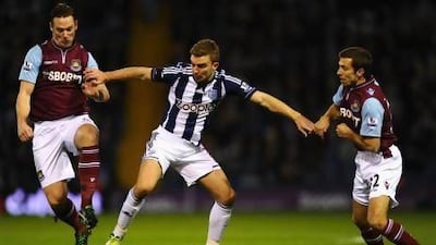 James Morrison, centre, the West Bromwich Albion midfielder, tries to fend off the challenge of two West Ham players. Laurence Griffiths / Getty Images