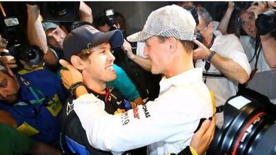 Michael Schumacher, right, congratulates Sebastian Vettel on winning the world championship at the Abu Dhabi Grand Prix at Yas Marina Circuit last weekend.