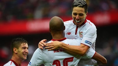 Sevilla's French midfielder Steven N'Zonzi (back) celebrates his goal against Atletico Madrid with teammate Samir Nasri. Cristina Quicler / AFP