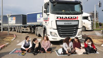 Israeli right-wing protesters block lorries carrying humanitarian aid bound for Gaza, at the entrance to Ashdod port in southern Israel, February 2024. EPA