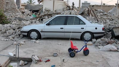 A car is buried under the rubble. EPA / MOHAMAD FATEMI