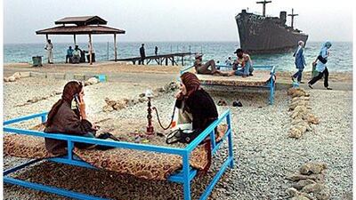 A rusting ship idles close to Kish's shore.