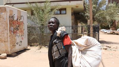 A Sudanese woman carrying her belongings on a street in Khartoum. Sudan's civil war has displaced nearly eight million people. EPA