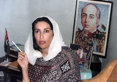 Benazir Bhutto holds a press conference in front of a poster of her father, executed prime minister Zulfikar Ali Bhutto, at her home on November 1988 in Larkana, as she won first parliamentary elections. Douglas Curran / AFP