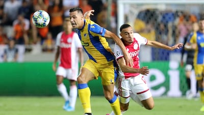 APOEL Nicosia's Lucas Souza fights for the ball against Ajax Amsterdam's Noussair Mazraoui. EPA