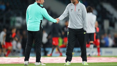 Derby County manager Nigel Pearson, left, shakes hands with Liverpool manager Jurgen Klopp. Richard Heathcote / Getty Images