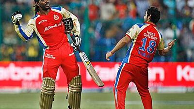 Chris Gayle, left, and Virat Kohli celebrate beating Chennai by eight wickets in their final IPL league match.