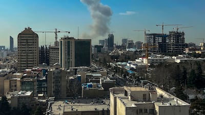 A plume of smoke rises following a reported explosion in Tehran on February 28, 2026. AFP