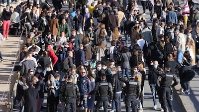 French Gendarmes try to disperse Parisians, out in their droves, as they gather along the River Seine that runs through the centre of the capital Paris. France has so far avoided a third lockdown to battle Covid-19 but, with case numbers starting to rise, the government of President Emmanuel Macron is beginning to impose restrictions on a local basis. AFP