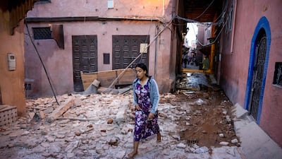 A woman walks through rubble in the old city of Marrakesh on September 9. AFP