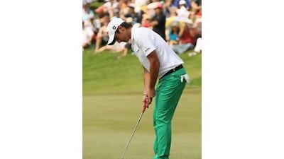 Matteo Manassero taps in at the 18th hole to finish a round of 68 and win the Malaysian Open yesterday.