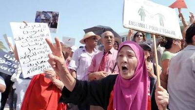 A Tunisian woman holds a sign reading "Together for Equality" during a protest calling for the respect of women's rights in front of the headquarters of the National Constituent Assembly last year. Fethi Belaid / AFP