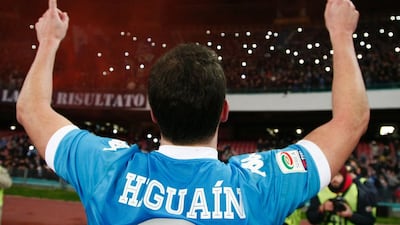Napoli forward Gonzalo Higuain celebrates with fans after winning the Italian Serie A match against Sassuolo Calcio at the San Paolo stadium in Naples on January 16, 2016. / AFP / CARLO HERMANN