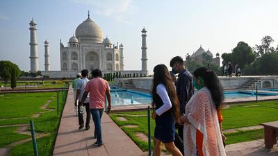 Tourists visit the Taj Mahal after it reopened to visitors following authorities easing Covid-19 coronavirus restrictions in Agra. AFP