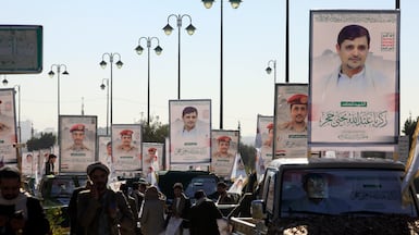 Vehicles carry portraits of senior Houthi military leaders who were killed in a US air strike, during a funeral procession at a mosque in Sanaa. EPA