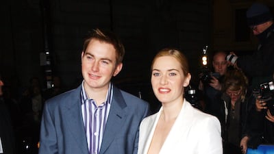 Kate Winslet, in a white blazer, and her brother arrive for the premiere of 'Iris' on January 13, 2002 in London, England. Getty Images
