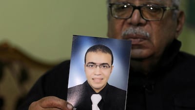 Reda Abdullah al-Hamamy, the father of Abdullah Reda al-Hamamy who is suspected of attacking a soldier in Paris’ Louvre museum, holds a picture of his son. Mohamed Abd El Ghany / Reuters