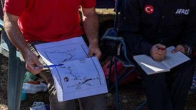 A rescuer holds a map of the Morca Cave during a meeting as a rescue operation continues to reach U. S. caver Mark Dickey. Reuters