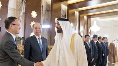 Sheikh Mohammed bin Zayed greets a member of the Chinese delegation. Crown Prince Court - Abu Dhabi