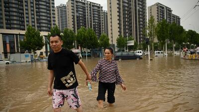 Walking hand-in-hand in search of refuge from the flood.