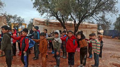 Children attend class in makeshift classrooms at a camp for the displaced by the village of Killi, near the border with Turkey, in Syria's northwestern Idlib province.