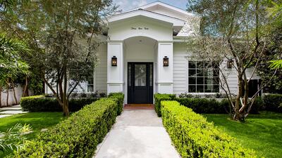 The home has an understated white facade. Courtesy Engel & Volkers