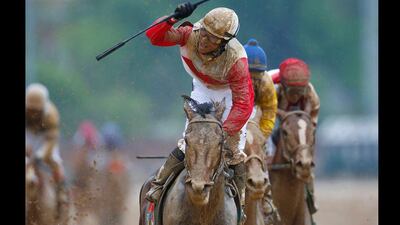 Jockey Joel Rosario celebrates after crossing the finish first on Orb during the Kentucky Derby. (Jeff Haynes / Reuters)