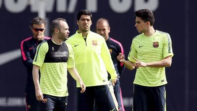 Barcelona's Andres Iniesta, Luis Suarez and Marc Bartra attend a training session on Monday for their Champions League match against PSG on Tuesday. Albert Gea / Reuters
