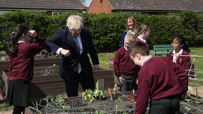 Boris Johnson elbow bumps a pupil during the visit. Getty Images