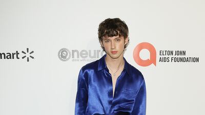 Troye Sivan, in blue silk, at the Elton John Aids Foundation Academy Awards Viewing Party on February 9, 2020 in Los Angeles, California. AFP