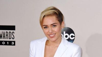 Miley Cyrus arrives at the American Music Awards at the Nokia Theatre. Jordan Strauss / Invision / AP