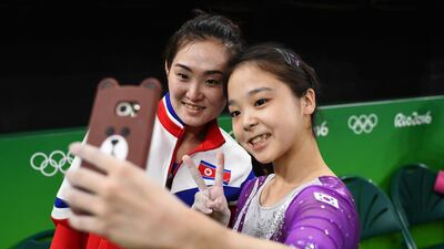Gymnast Lee Eun-Ju (KOR) of South Korea (R) takes a selfie picture with Hong Un Jong (PRK) of North Korea during training for the Olympics in Rio de Janeiro, August 4,2016 Dylan Martinez / Reuters