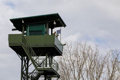 A Greek border guard in an observation tower at the frontier with Turkey. Bloomberg