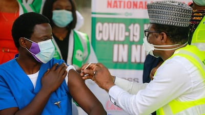 Dr Ngong Cyprian receives his first dose of the Oxford/AstraZeneca Covid-19 vaccine from Dr Faisal Shuaib, Executive Director and Chief Executive Officer of the National Primary Health Care Development Agency, at the National hospital in Abuja. Reuters
