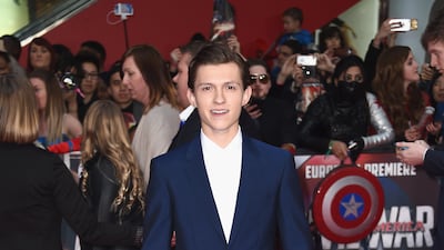 Tom Holland, in a navy suit and white shirt, arrives for UK premiere of 'Captain America: Civil War' in London on April 26, 2016. Getty Images