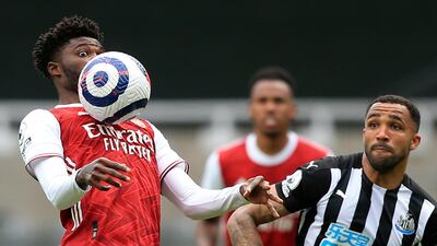 Arsenal's Thomas Partey, left, competes for the ball with Newcastle's Callum Wilson. AP