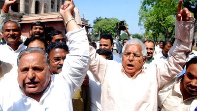 Yadav, left, holds hands with Rashtriya Janata Dal president Lalu Prasad Yadav during a protest against the proposed Women's Reservation Bill outside parliament in New Delhi in March 2010. EPA