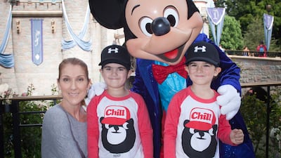 Dion with her twin sons Eddy, left, and Nelson, then aged four, for the boys' birthday with Mickey Mouse at Disneyland park in California in 2016. Getty Images