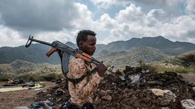 A member of the Afar Special Forces stands in front of the debris of a house in the outskirts of the village of Bisober, Tigray Region, Ethiopia. File Photo / AFP