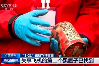 A search and rescue worker holds the second black box from Flight MU5735. The device was recovered on Sunday. CCTV / AP