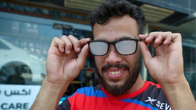 An auto technician's glasses steam up after leaving an air-conditioned office. Victor Besa / The National