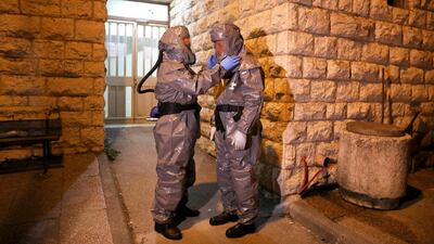 Ultra-orthodox Jewish members of the religious burial organisation Hevra Kadishah wear protective suits as they prepare to carry the coffin of 72-year-old French rabbi Masoud Hamu, who died from Covid-19, at a funeral home in Jerusalem, on March 26, 2020. EPA