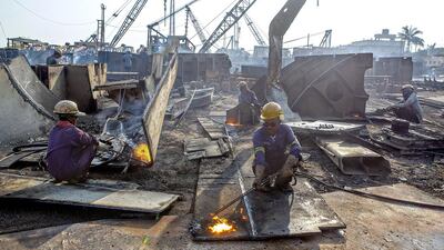 Workers Cut through metal Parts at a Ship Breaking yard at Alang. Subhash Sharma for The National