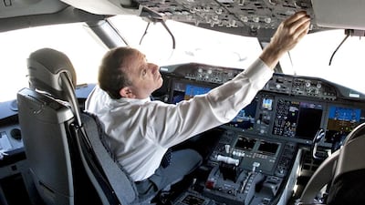 A pilot in the cockpit of a Boeing 787 Dreamliner at Dubai International Airport. Jeff Topping / The National